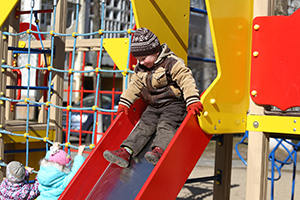 Boy going down slide