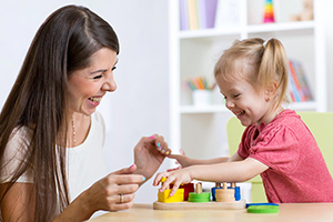 Woman and child sorting shapes