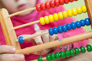 Child playing with abacus